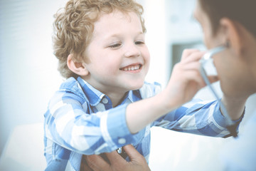 Doctor and patient child. Physician examining little boy. Regular medical visit in clinic. Medicine and health care concept