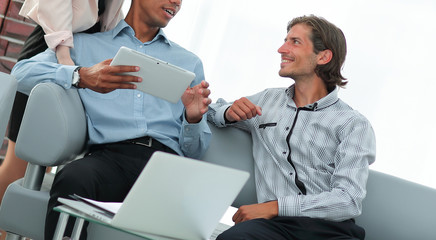 business team reading text on a digital tablet