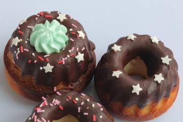 Chocolate coated cakes with decorative topping. Located in the shape of a triangle.