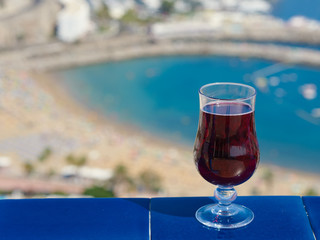 The glass of wine against the picturesque sea view illustrating the holiday and relax atmosphere.