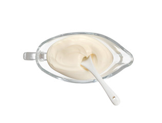 White cream sauce with a white spoon in a glass plate isolated on white. Top view. With clipping path