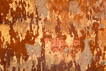 aged  heavily damaged concrete red wall with patches of gray cement. rough surface texture