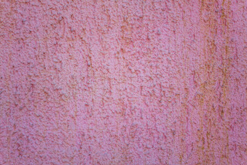 white pink grainy surface of the wall with deep relief. rough texture