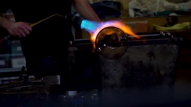 warming glass vase with a torch