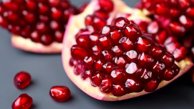 Rotating india pomegranate Seeds on black background in 4K resolution