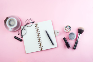 Workplace mockup with notebook, glasses and accessories on pink background top view. Flat lay with coffee copy space. Feminine working style concept.