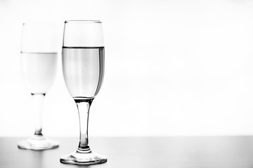 monochrome photo of champagne on white table on white background isolate