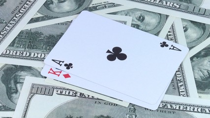Rotating background from money of US dollars and a combination of two-double cards it is in poker close-up.