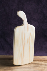 Birch chopping board  rectangular light wood standing on a table vertically