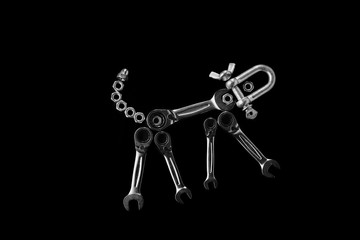 Nuts, bolts, tool wrench, ratchet on a dark background.