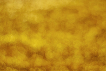 Glitter light abstract gold bokeh blurred background