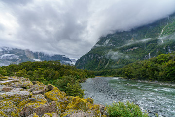 mountains in low hanging clouds, cleddau river, milford sound, new zealand 3
