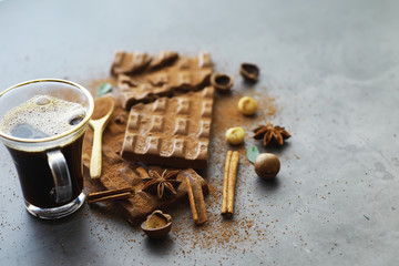 A bar of milk chocolate on the table. Chocolate with nuts and cinnamon.