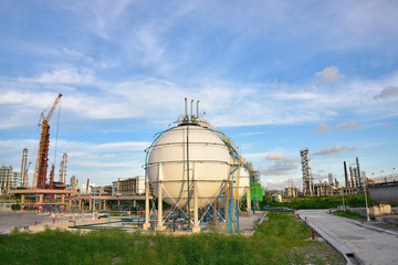 Oil refineries and oil tanks under the blue sky white clouds