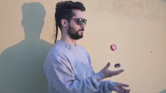 Juggler, Young Man wearing Sunglasses  Juggling  in Slow Motion video shot with gimbal