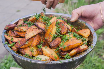 Fresh potato boiled in large restaurant frying pan. Picnic healthy food cooking at large metallic pan.
