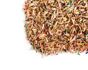 Background of wooden shavings colored pencils after sharpening with a knife closeup