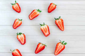 Strawberry fruits on the left side on wooden background.Top view .