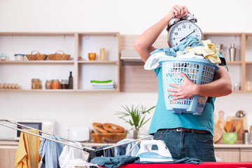 Young man husband doing clothing ironing at home 