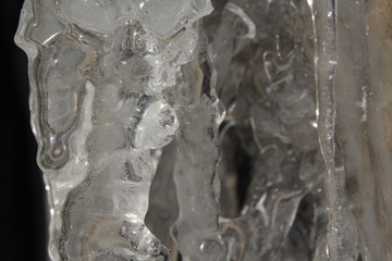 Icicles hanging on a ledge with rocky bacground