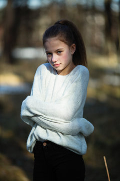 Cute Twelve Year Old Girl In The Park Posing For The Camera.