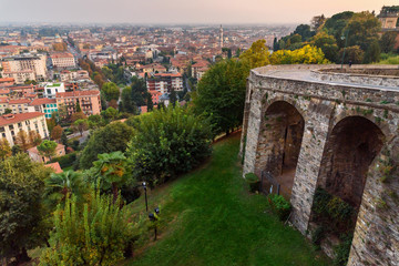 Fototapeta premium View of Bergamo and old bridge on Via Sant Alessandro street to upper city Cita Alta at sunset. Bergamo. Italy