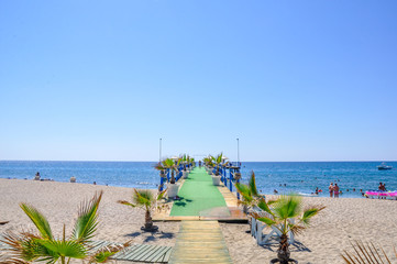 tropical beach with chairs and umbrellas