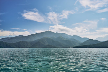 Beautiful sunrise scenics of Sun Moon Lake with the surrounding mountains are the highlight at this sprawling lake at Yuchi, Nantou in Taiwan.