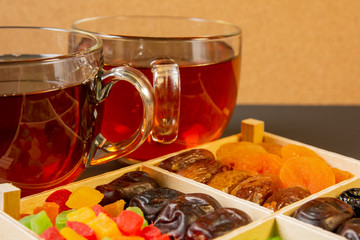 Oriental sweets, dried fruit with a cups of tea