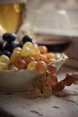 glasses of red and white wine and grapes