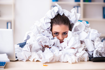 Businesswoman rejecting new ideas with lots of papers