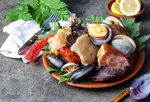 Famous traditional dish of the south of Chile and the Chiloe archipelago - Curanto al Hoyo, Kuranto.  Different seafood,  meat and potatoes milcao cooked in a pit on the coals under the ground