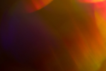 Blurry orange lights on dark background. Defocused lens flare glow. Abstract design.