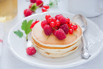 Homemade Pancakes with fresh red berries and honey