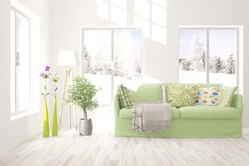 Stylish room in white color with sofa and winter landscape in window. Scandinavian interior design. 3D illustration