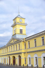 Fototapeta na wymiar City Clock Tower over the yellow house, urban architecture