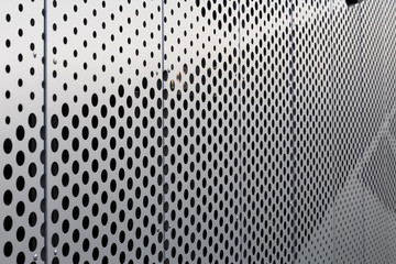 Perforated metal panel. Facing of buildings and structures perforated metal siding. Horizontal.