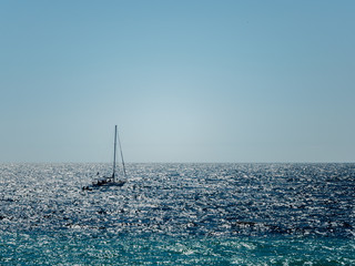 Sailboat in bright shiny sea water