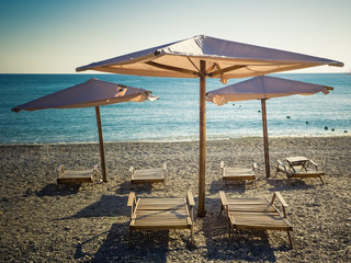 Sun umbrellas and beach beds on the sea beach