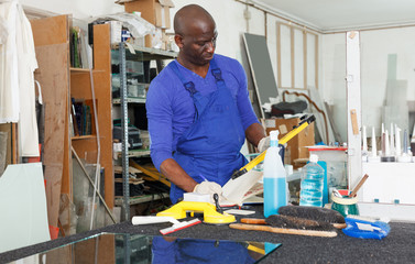 glass factory worker noting measurement or order data in notebook