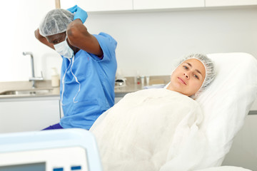 Female in armchair before facial procedure in clinic of esthetic cosmetology