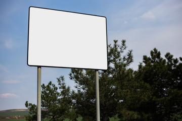 Empty billboard blank for advertising, on background of cloudy sky.