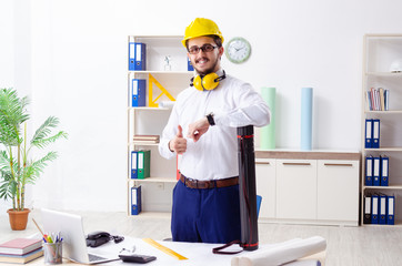 Young male architect working in the office 