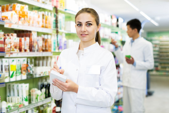 Female pharmacist standing in drugstore
