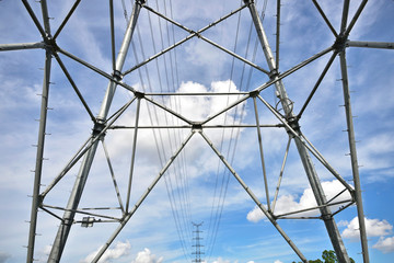 High voltage towers in the blue sky white cloud background