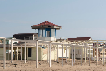 rescue tower on a sandy beach. the tower was not photographed during the summer season. there are no rescuers on the tower and no people either. near the tower is a place in shizlong. in the