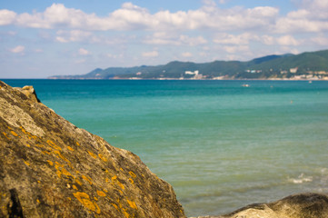 Obraz premium rocky sea shore with pebble beach, waves with foam