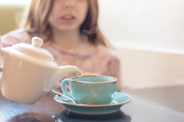 girl pours hot tea. selective focus