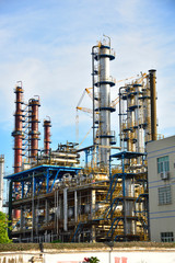 Fototapeta premium Close-up of pipelines and destillation tanks of an oil-refinery plant