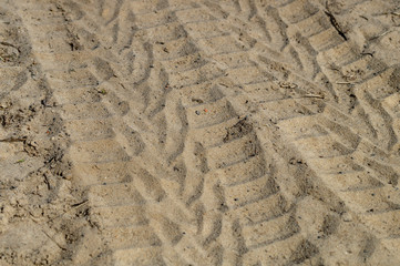 track, the imprint of the wheels of the SUV car on the sand close-up